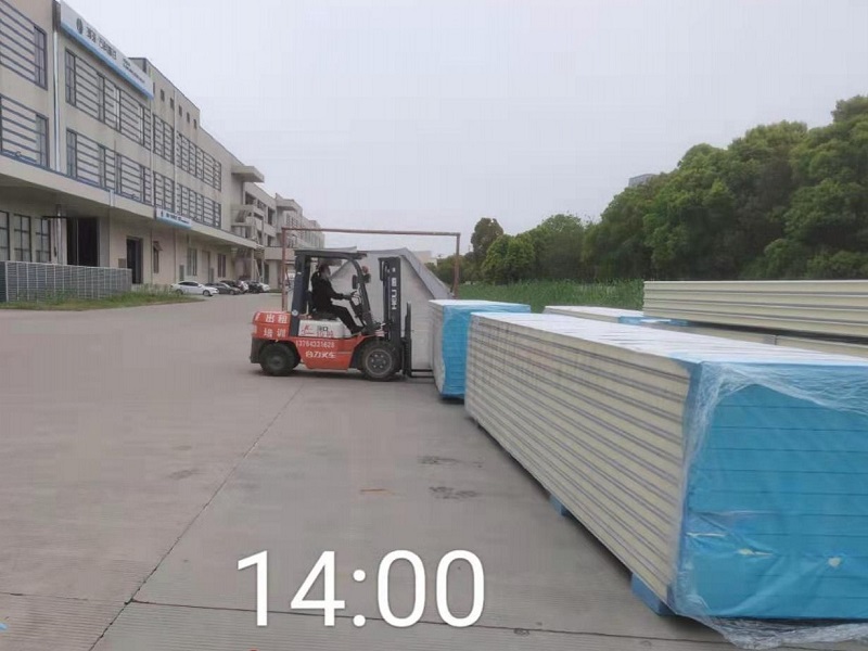 图为工人正在卸库板
